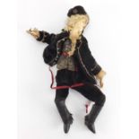 Early 20th century French hand painted plaster doll wearing traditional dress, approximately 28cm in