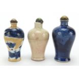 Three Chinese porcelain and stoneware snuff bottles with stoppers of Meiping form, two hand
