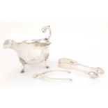 Silver objects comprising three footed sauce boat, wishbone sugar nips and a pair of Victorian sugar