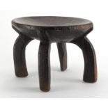 Tribal interest African carved hardwood four footed stool, 24.5cm high x 31cm in diameter :For