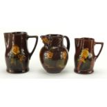 Three Royal Doulton Kingsware jugs comprising an example decorated with Dickens characters, Would