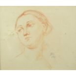 Portrait of a young female, red chalk, bearing a signature John 1929, mounted and framed, 25.5cm x