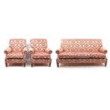 Pink floral upholstered three seater settee and two matching armchairs, the settee 180cm wide :