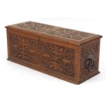 Rectangular oak chest with ring turned handles, carved with flower heads and stylised foliage,