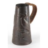 Arts & Crafts Newlyn School copper jug, the tapering body embossed with two birds, 15cm high :For