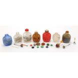 Seven Chinese hardstone and glass snuff bottles together with a group of stoppers, including reverse