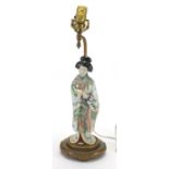 Japanese porcelain figural and gilt hardwood lamp, the female holding a fan hand painted with