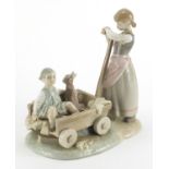 Lladro figure group of a girl pulling a boy and dog in a cart, 21.5cm high : For Further Condition