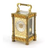 French brass cased carriage clock striking on a gong, with architectural columns and gilt blind fret