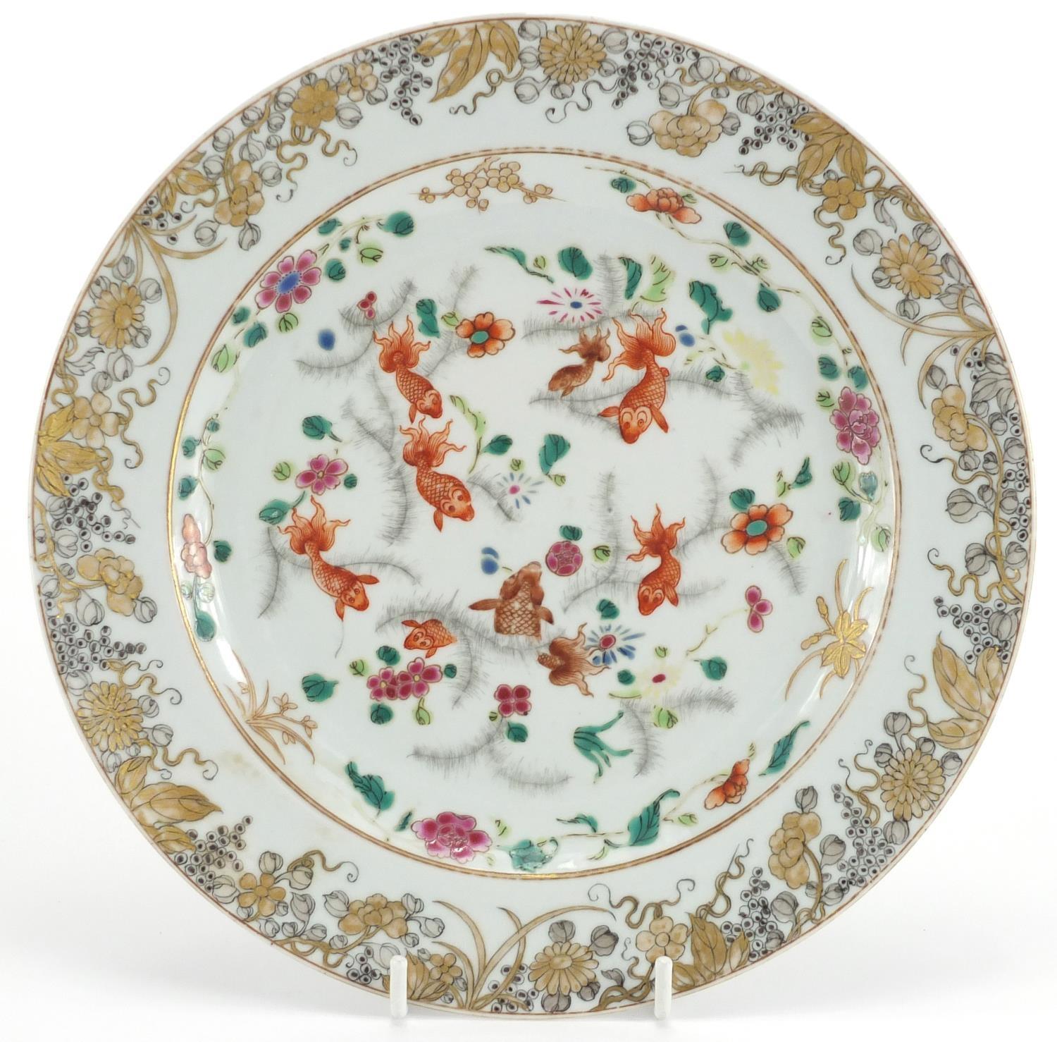 Chinese porcelain plate, hand painted in the famille rose palette with fish swimming within a gilt