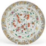 Chinese porcelain plate, hand painted in the famille rose palette with fish swimming within a gilt