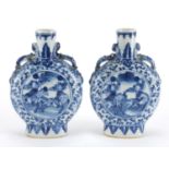 Pair of Chinese blue and white moon flasks with twin handles, each hand painted with warriors and