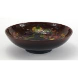 Moorcroft pottery Flambe footed bowl, hand painted and tube lined with flowers, paper label,