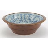 Chinese brown glazed blue and white porcelain basin, the interior hand painted with foliate