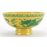 Chinese porcelain yellow ground footed bowl, hand painted with two dragons chasing the flaming pearl