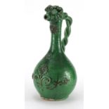Turkish Canakkale pottery wine jug, having an all over green glaze, with an applied floral design,