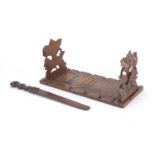 Black Forest carved wooden extending book slide and page turner, the largest 35cm wide : For Further