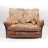 Ercol Renaissance two seater settee, with floral upholstered lift off cushions, approximately
