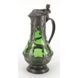 Art Nouveau pewter and green glass lined ewer in the style of WMF, the pewter body cast with