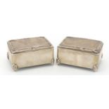 Pair of rectangular silver jewel boxes, the hinged lids with embossed decoration, by W J Myatt & Co,