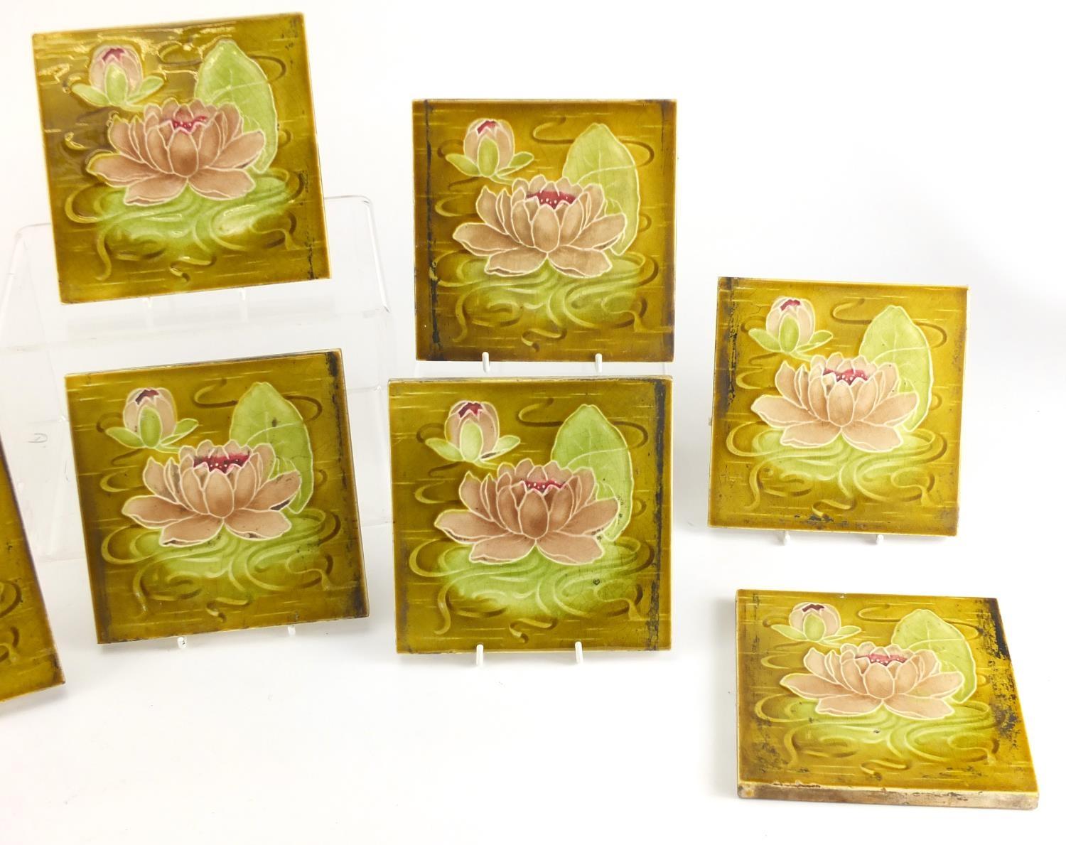 Ten Art Nouveau Maiolica tiles by Alfred Meakin, each hand painted with lily's, each 15.5cm x 15.5cm - Image 3 of 4