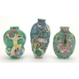 Three Chinese porcelain turquoise ground snuff bottles, comprising two relief examples and one