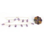 Pearl and amethyst coloured glass necklace and a Scottish hardstone brooch, the necklace 58cm in