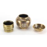 Two Egyptian Cairoware pots and a bowl two with copper and silver inlay, each decorated with script,