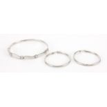 9ct white gold bracelet set with clear stones and a pair of 9ct white gold hoop earrings,