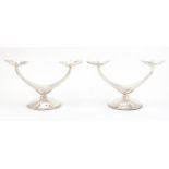 Pair of Danish silver two branch candelabra, each stamped 835 WTB, 11cm high x 19cm wide,