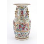 Chinese porcelain Canton vase with twin handles and relief dragon decoration, finely hand painted in