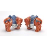 Pair of Chinese porcelain models of elephants, the saddles hand painted with tree's, each 19cm