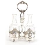 Art Nouveau Silver plated condiment set by WMF, housing a pair of cut glass bottles with stoppers,