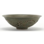 Chinese green glazed pottery bowl, pierced and decorated in low relief with phoenixes amongst