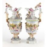 Pair of 19th century continental porcelain ewers, hand painted and decorated in relief with nude
