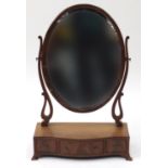 Oval mahogany toilet mirror, the serpentine fronted base with three drawers, 72cm high : For Further