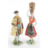 Pair of Portuguese hand painted porcelain figures, each carrying flowers, impressed Portugal to