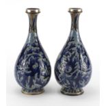 Pair of 19th century Doulton Lambeth vases with unmarked silver rims, incised and hand painted