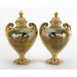Pair of Crown Devon vases and covers with twin gilt handles, each hand painted with Spaniels and
