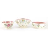 Two Maling lustre bowls and a centre vase, each decorated with flowers, the largest 16.5cm high :