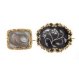 Two Victorian gilt metal mourning brooches, one with black enamel and seed pearls, the largest 4.5cm