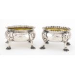 Matched pair of Georgian silver four footed open salts with gilt interiors, one dated London 1823,