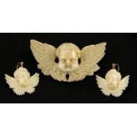 Well detailed Victorian carved ivory cherub pendant and similar earrings, the pendant 6.5cm wide,