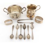 Silver items comprising twin handled cup, Christening tankard, two napkin rings, six silver