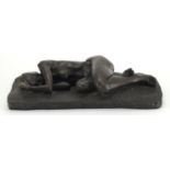 Bronzed sculpture of a sleeping nude female, the tiled base incised with stylised motifs and