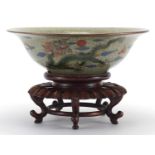 Chinese crackle glazed stoneware bowl, hand painted with a fish on carved hardwood stand, the bowl