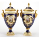 Pair of Coalport vases and covers with twin rams head handles, each hand painted with panels of