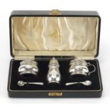 Silver three piece cruet with blue glass liners by Adie Brothers Ltd, Birmingham 1936, housed in a