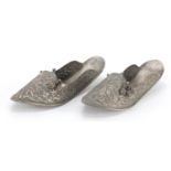 Pair of Middle Eastern unmarked silver slippers, embossed with foliate motifs, each 17cm in