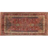 Rectangular Persian rug, having an all over floral design, onto a predominately red ground, 267cm